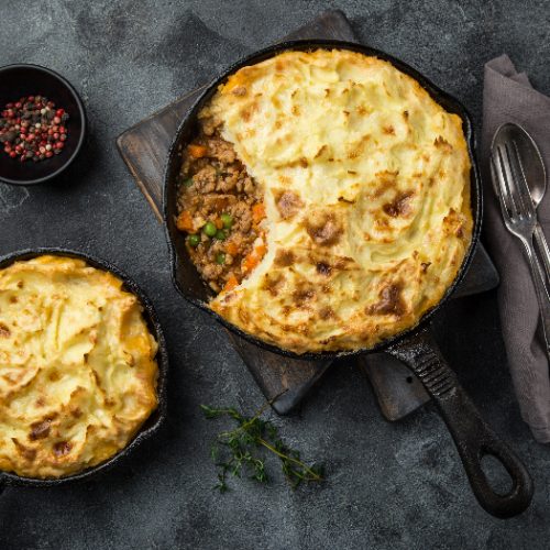 shepherd's pie made of minced meat, mashed potatoes and vegetables casserole in cast iron pan