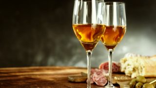 Two large wine glasses filled with sherry
