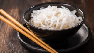 A bowl of shirataki noodles with chopsticks