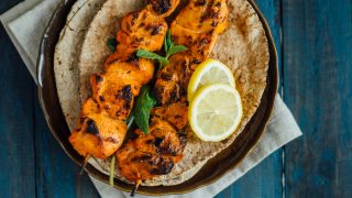 Delicious boneless chicken kebab on skewer served on arabic pita bread