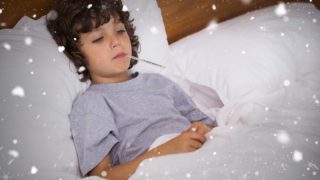 A sick child lying in bed