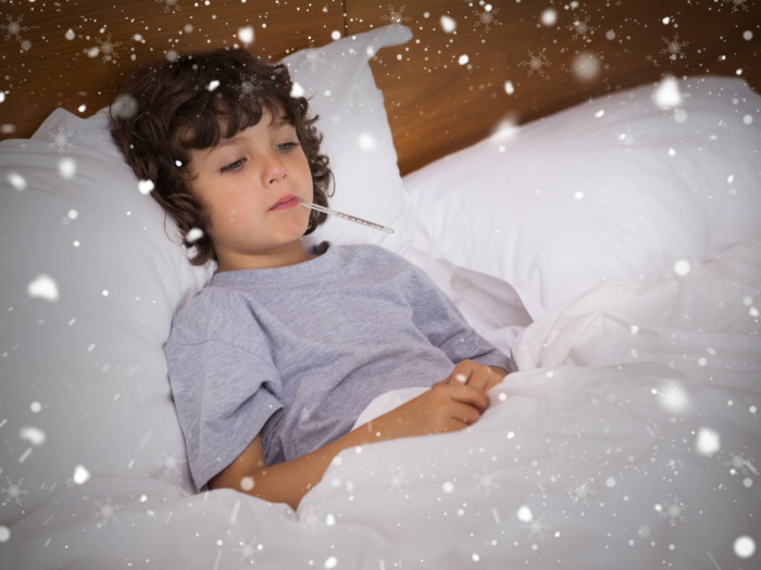 A sick child lying in bed