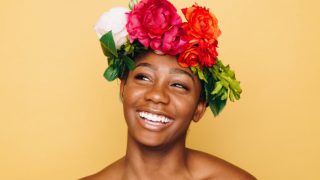 Smiling woman wearing a crown of roses.