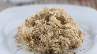 Extreme close-up of dried slippery elm on a white plate.