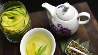 A flat lay picture of smoking tea next to a bowl of smoking tea leaves