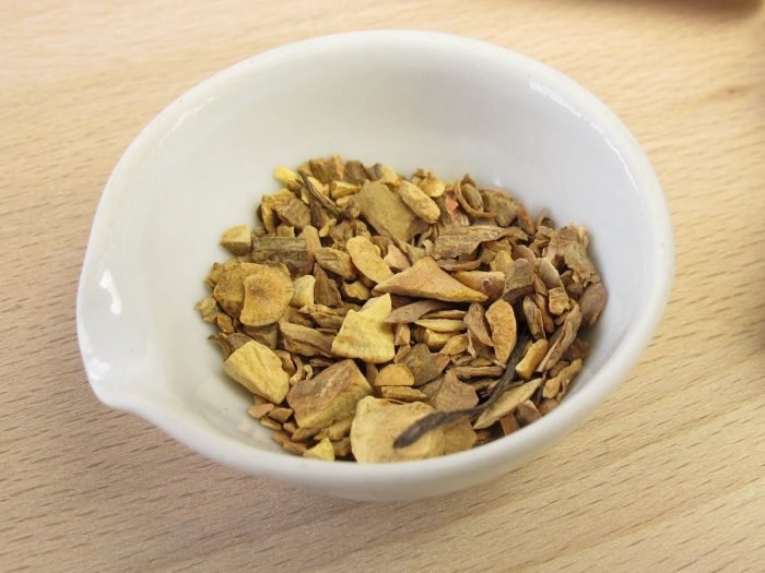 Close up of pieces of dried Indian snakeroot in a white bowl