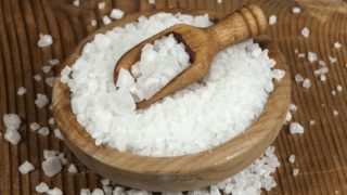 salt in a wooden bowl with a spoon