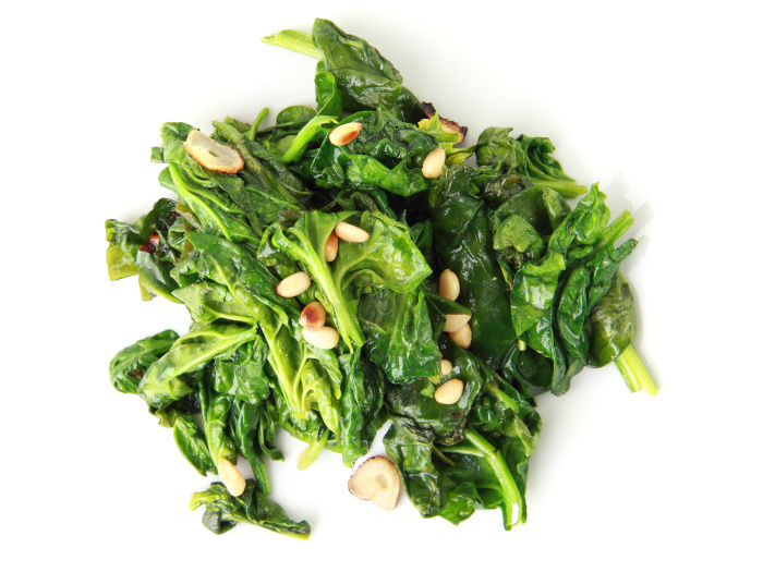 Spinach with garlic on a white background