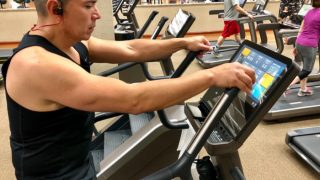A man exercising in the gym using a Stairmaster