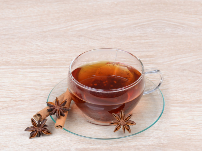 Star anise tea in a cup and anise kept around the cup