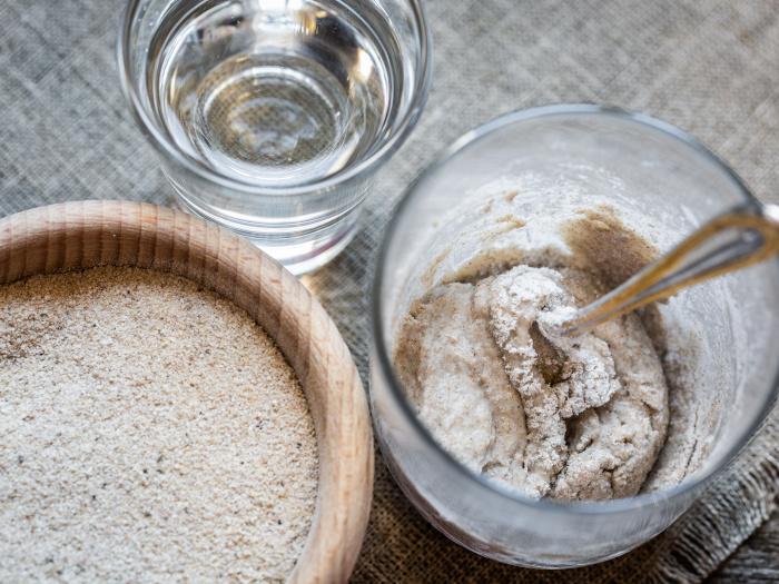 Glass of water, wet flour and bowl of flour