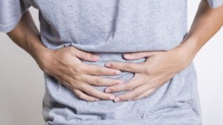 Man clutching his stomach