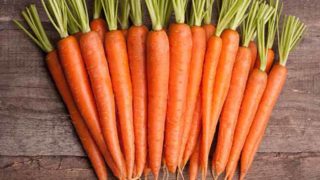 Fresh and sweet carrots on a wooden table