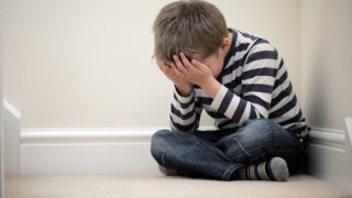 Child feeling upset due to bullying and depression