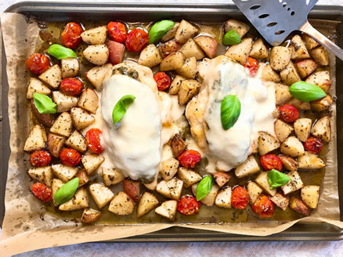 Stuffed pesto chicken on a bed of vegetables