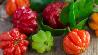 Different colored Surinam cherry on a wooden table