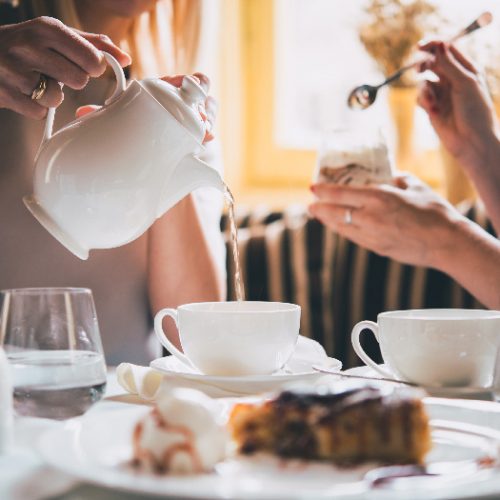 Tea time with two people enjoying tea and tea time desserts