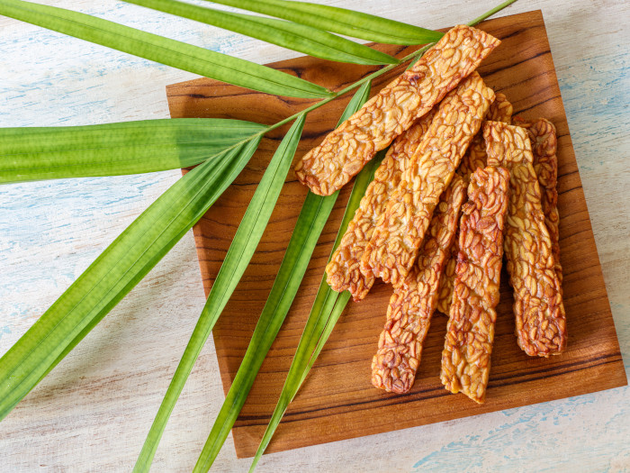 Top view of tempeh pieces on a wooden board