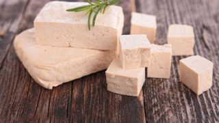 Tofu pieces on a wooden counter