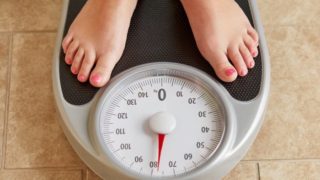 A woman's feet on a weight scale.
