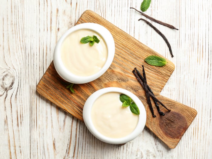 A flat lay picture of two bowls carrying vanilla pudding