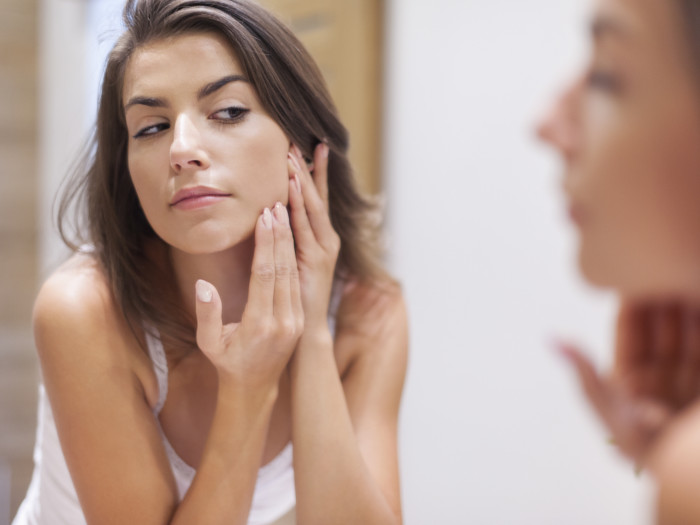 Woman touching her face
