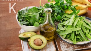 Kale, avocado, beans, parley, and banana on a wooden tray