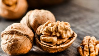 Loose walnuts on a wooden table