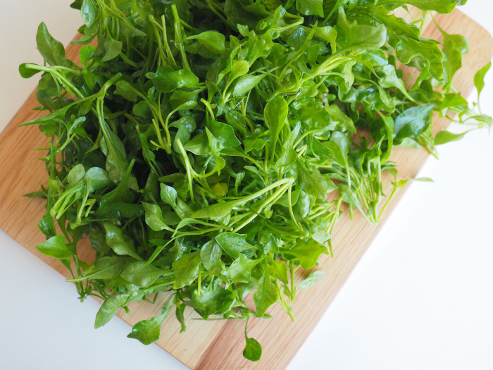 Watercress on a wooden cutting board