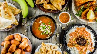 Traditional African dishes - peanut soup, jollof rice, chicken wings, bananas plantains, chicken kebabs, meat pies