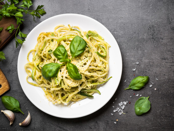 Top-view of a white pasta dish on a slate background