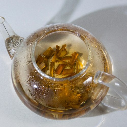 Close up of a teapot with tea made of willow bark