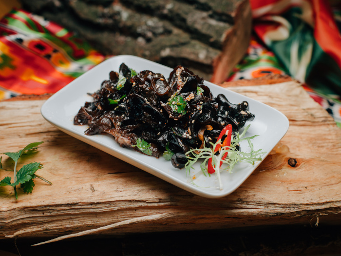 Korean salad made from wood mushrooms on a white plate