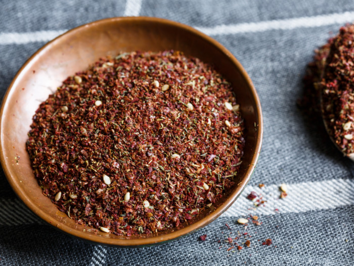 Close up of za'atar spice in a bowl on a grey and white table cloth